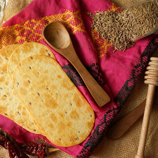 Close-up of crunchy Ragi Diet Thins with a hint of jeera seasoning, ready to eat.